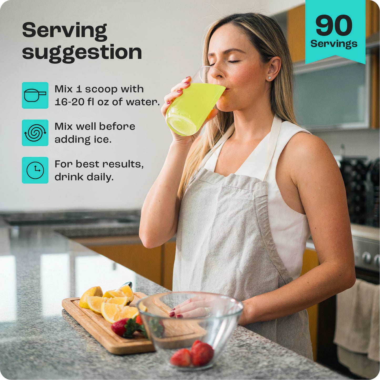 Woman in kitchen drinks yellow Electrolyte Recovery Plus Powder; serving instructions and fruit visible.