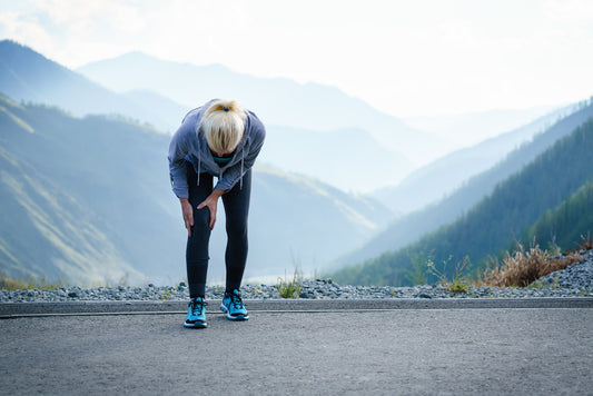 woman runner holding leg