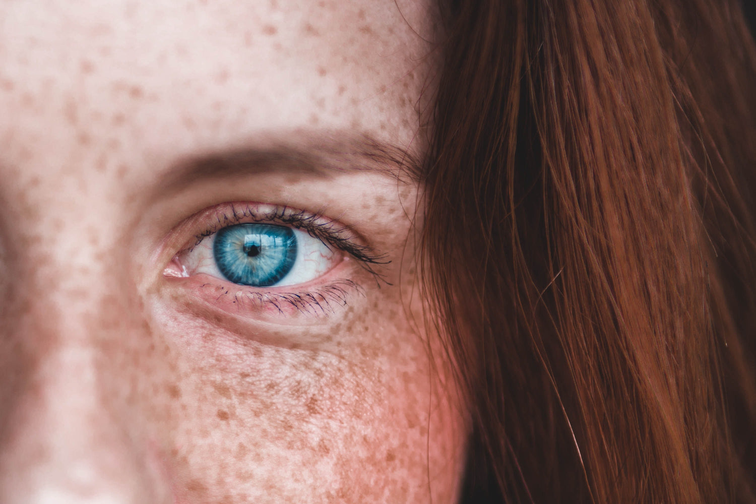 woman with freckles blue eyes and red hair