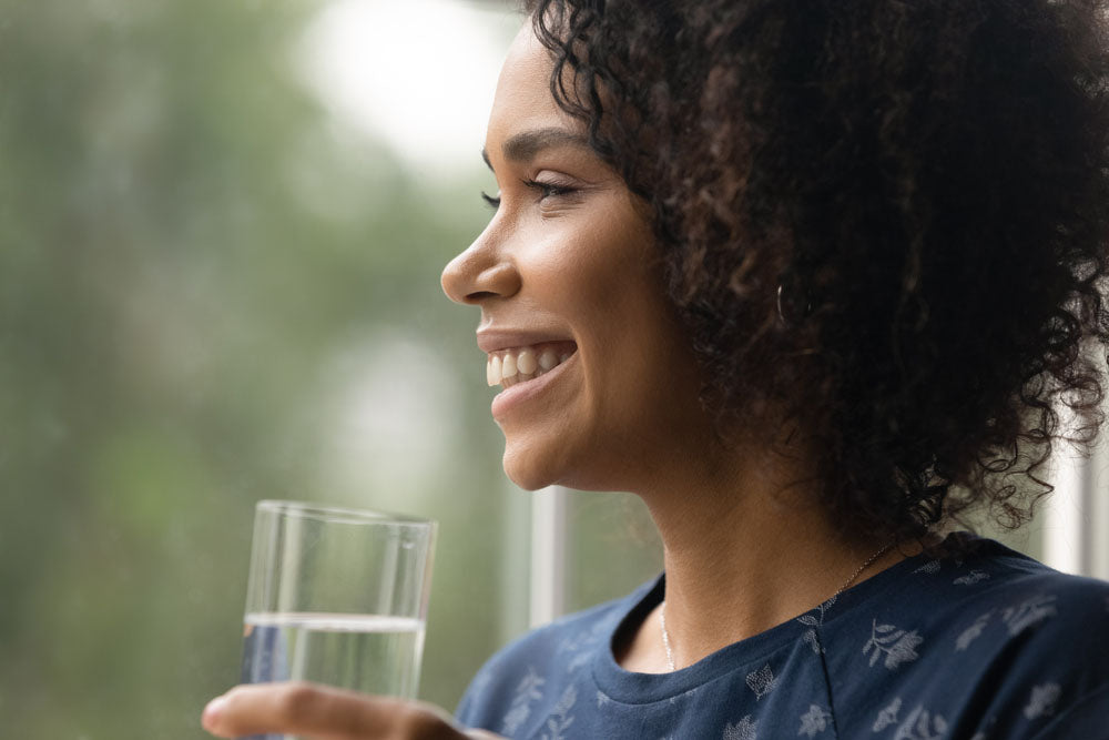 portrait smiling woman drinking water