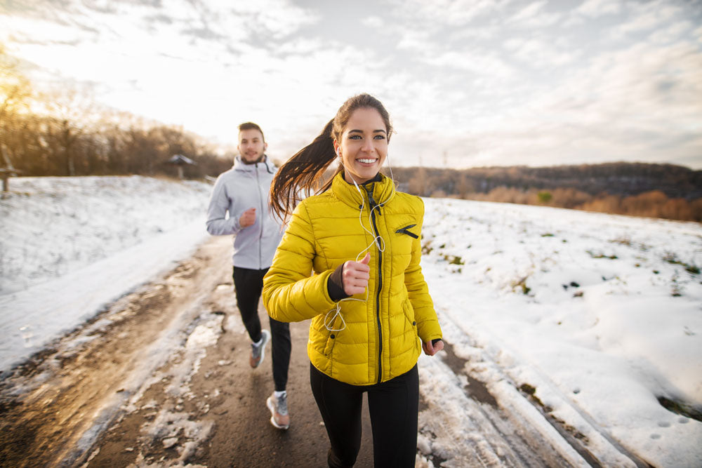 runners on snowy trail