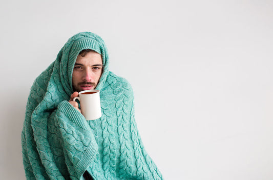 sick man wrapped in blanket