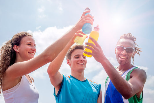 trio friends drinking sports drink