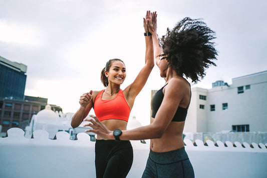 two women high fiving