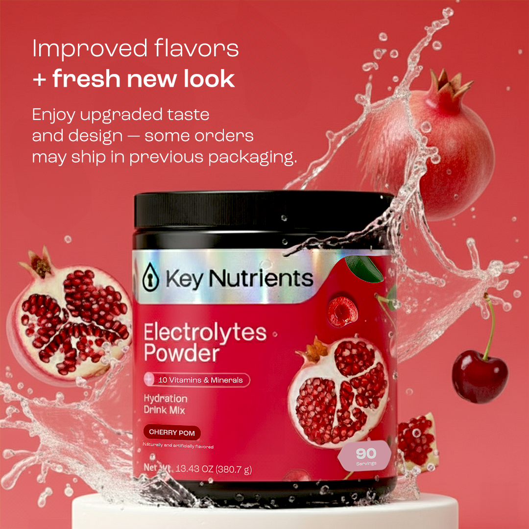 A jar of Electrolyte Recovery Plus Powder (Sugar-Free), pomegranate and cherry, with water splashing.