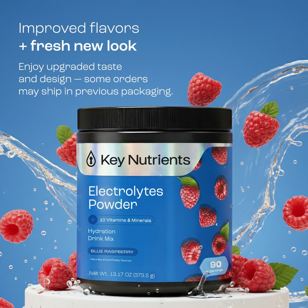 A blue container of Electrolyte Recovery Plus Powder (Sugar-Free) with raspberries and splashing water.