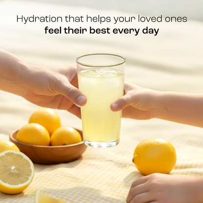 Adult and child hands hold a glass of Electrolyte Recovery Plus Powder (Sugar-Free), with fresh lemons nearby.