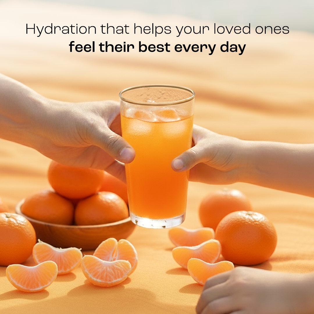 Two hands share a glass of Electrolyte Recovery Plus Powder (Sugar-Free), with fresh oranges on the table.
