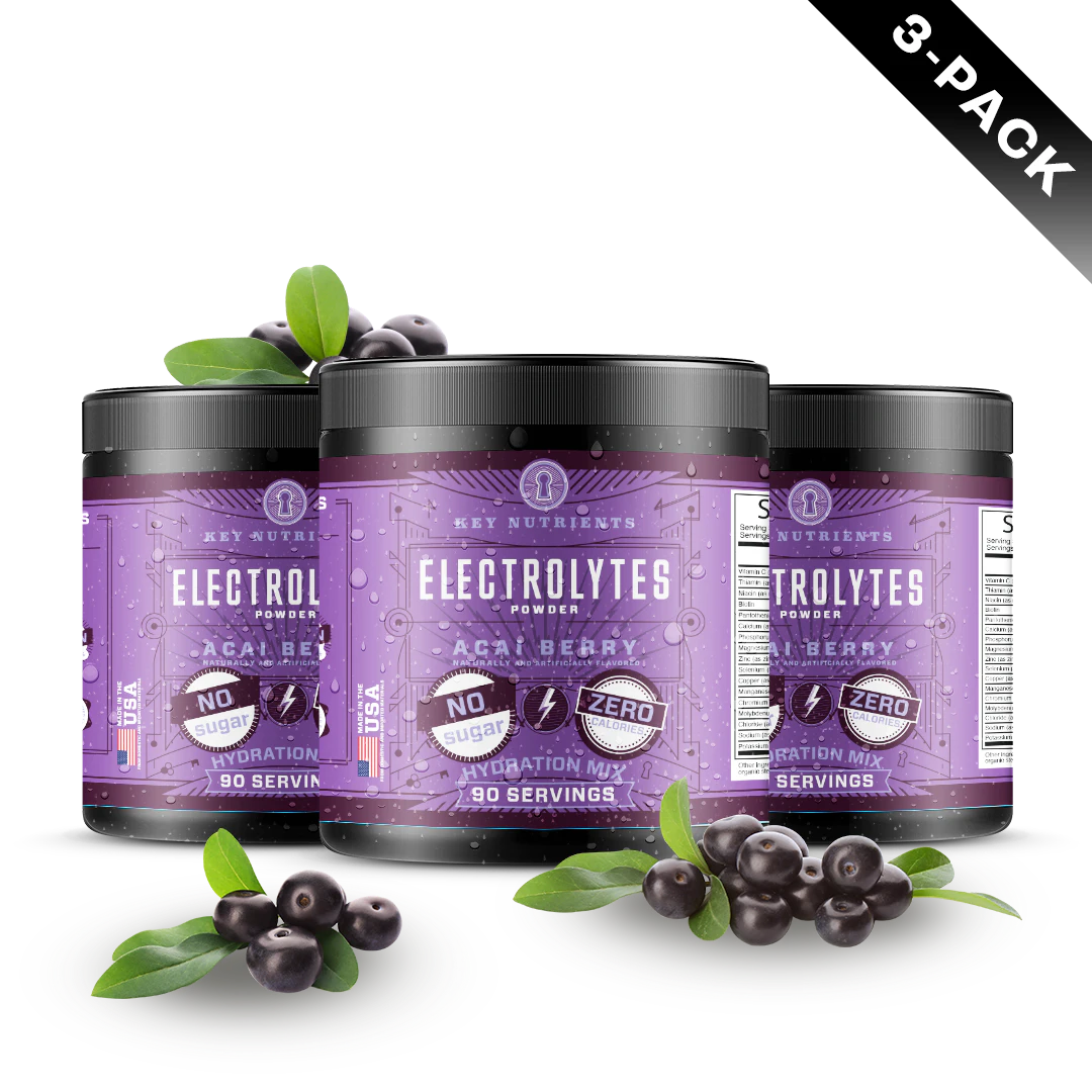 Three jars of Electrolyte Recovery Plus Powder (Sugar-Free) sit elegantly, surrounded by fresh acai berries and lush leaves, offering the perfect hydration drink for those seeking a delicious boost.