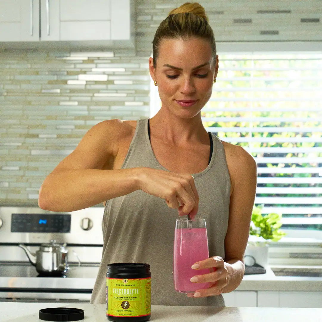 woman mixing KN electrolytes w/ water