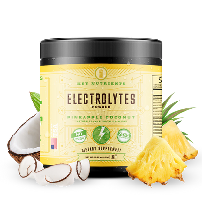 Electrolyte Recovery Plus Powder (Sugar-Free) container surrounded by coconut and pineapple chunks, ideal for a keto diet-friendly hydration drink.