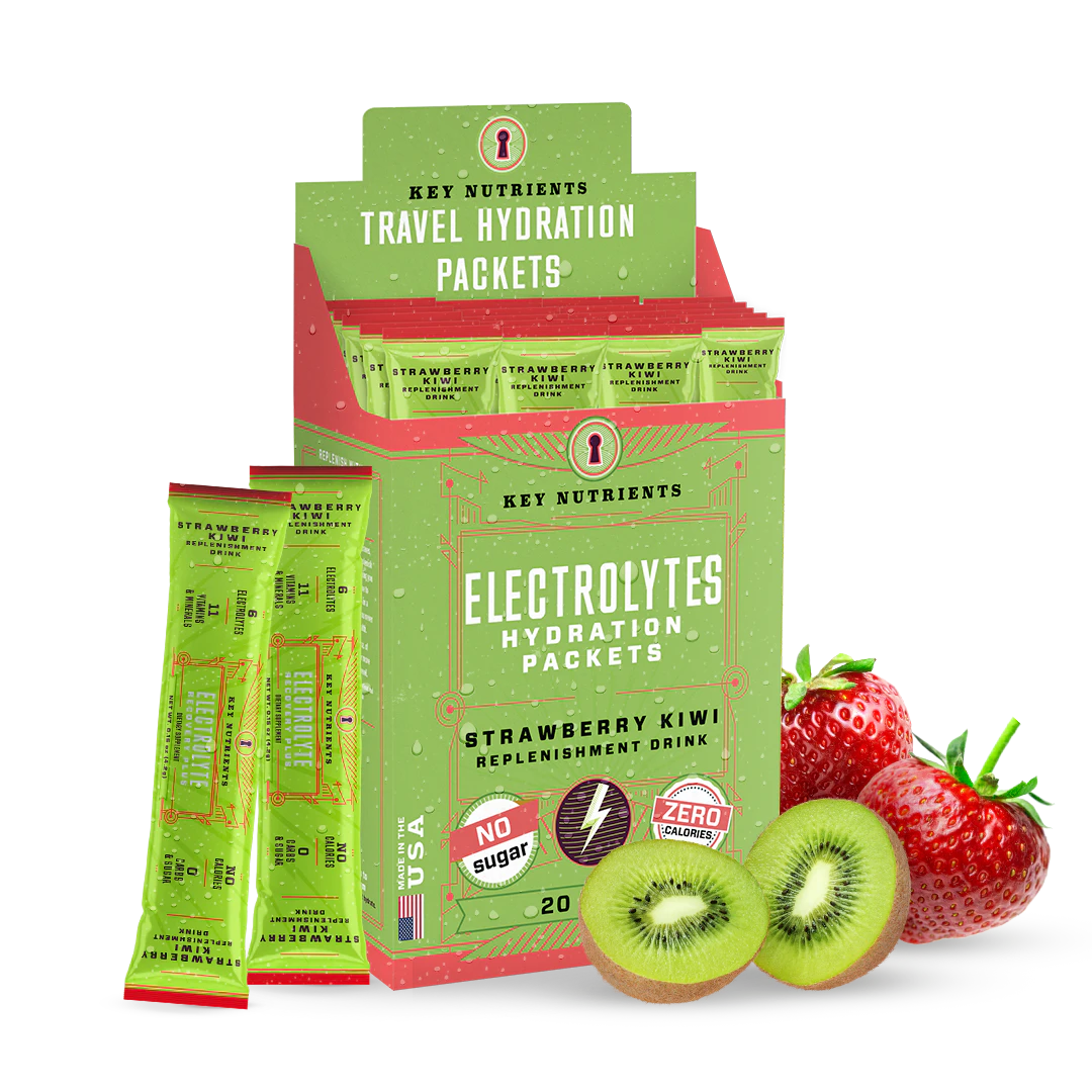 A green box of Electrolyte Recovery Plus Powder (Sugar-Free) packets is positioned next to fresh strawberries and kiwis. Ideal for a refreshing Hydration Drink, this blend is Keto Diet Friendly, offering taste without compromise.