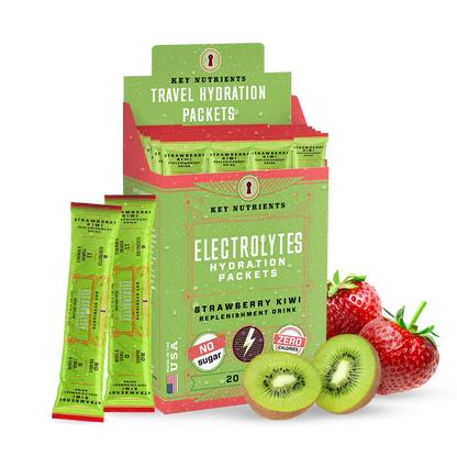 A green box of Electrolyte Recovery Plus Powder (Sugar-Free) packets is positioned next to fresh strawberries and kiwis. Ideal for a refreshing Hydration Drink, this blend is Keto Diet Friendly, offering taste without compromise.