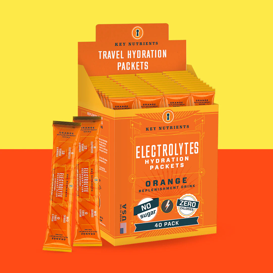 Electrolyte Recovery Plus Powder (Sugar-Free) in orange-flavored packets come in a display box and are labeled as having zero sugar and calories. Ideal for a Keto Diet Friendly lifestyle, these convenient electrolyte powder packets help maintain hydration without added sugars or calories.